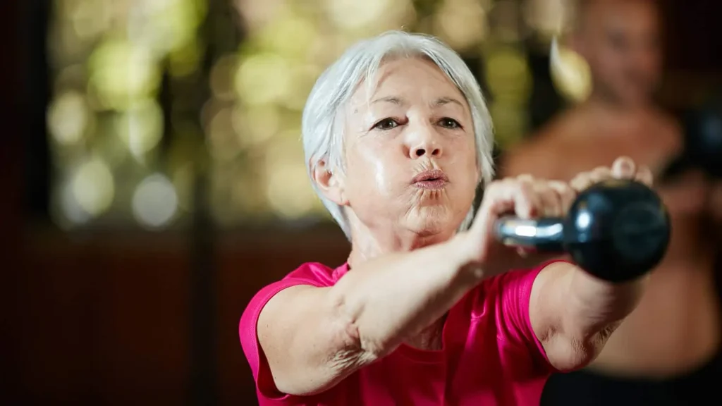 Toning Bingo Wings: Effective Exercises and Tips for Achieving Sleeker Arms 2 Person performing arm exercises with dumbbells Bakewell