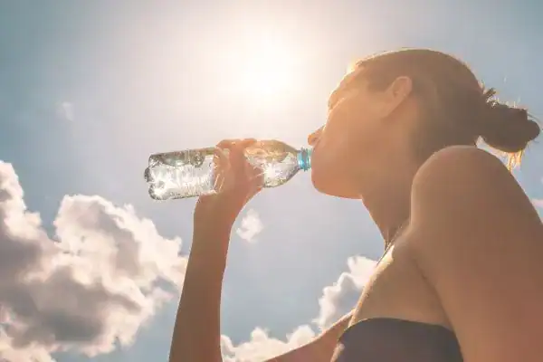 Hydration: The Secret Ingredient for a Toned Stomach and Enhanced Fitness 3 Image of woman drinking water to hydrate Bakewell after run.